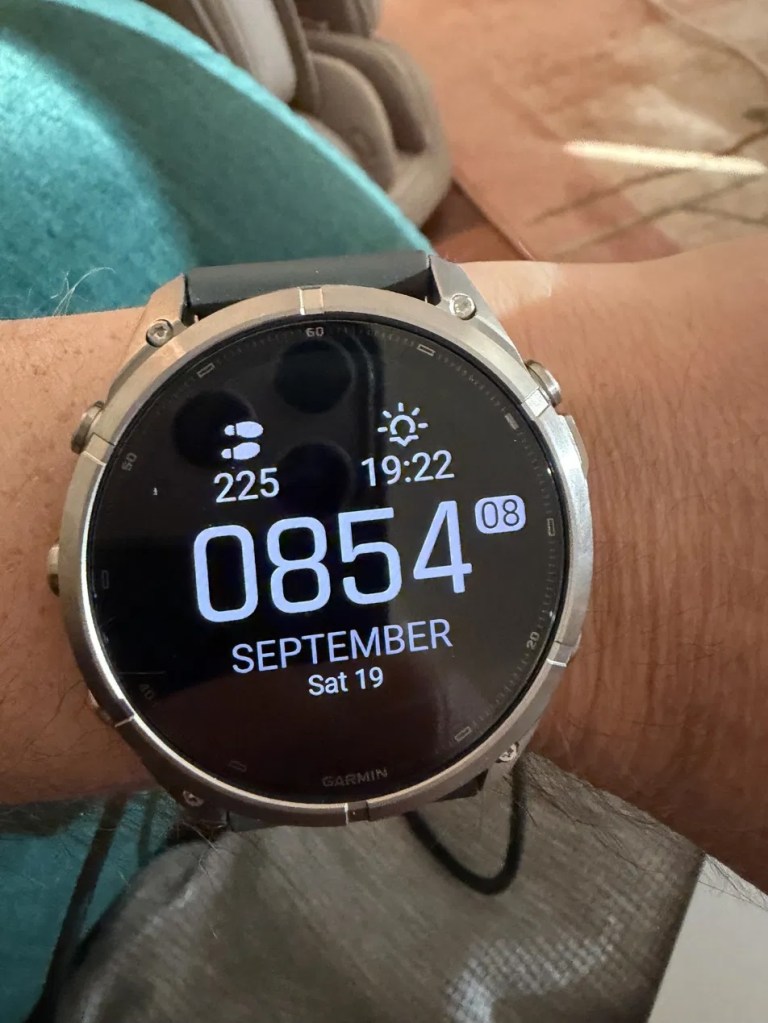 A close-up of a Garmin smartwatch displaying the time 08:54, date as September 19, and the day as Saturday.